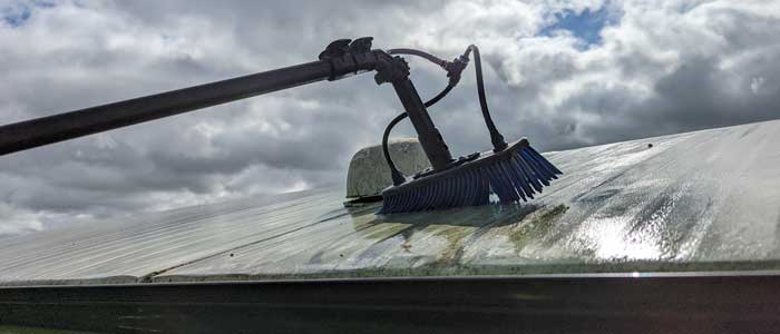 cleaning the roof of a static caravan using a water fed pole