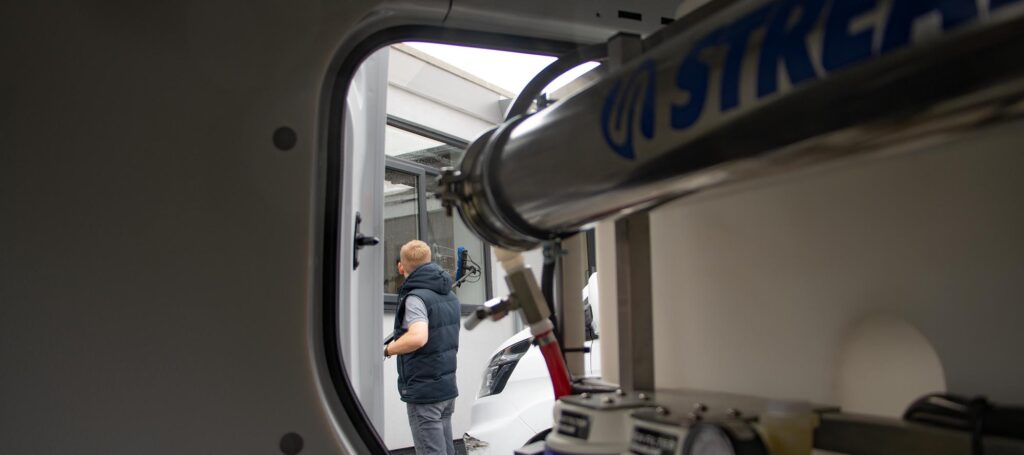 Viewing a window cleaner from the inside of their van